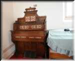 At the far end, there is an antique pipe organ (brought all the way from New York).